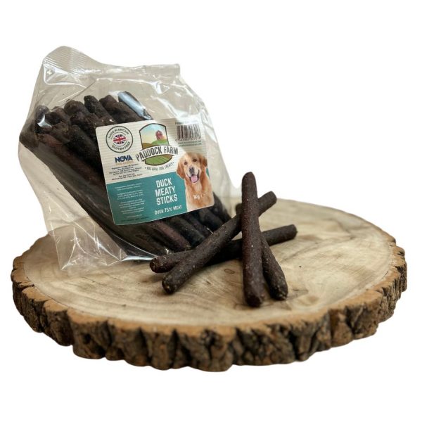 1kg pack of Duck flavoured sausages natural dog treats on a wooden display plate, with 4 loose sausages in front