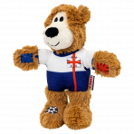 A three-quarter side view of the KONG Wild Knots England Bear facing left. The pose highlights the toy's soft limbs and durable football jersey. The red St George's Cross stripe extends down the side of the blue "shorts" section of the kit. The shaggy ears and sturdy plush body are clearly visible, illustrating the bear's friendly appearance and play-ready design.