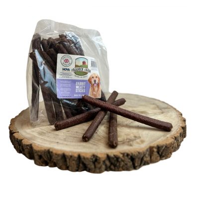 Bag of meaty dog treat sausages, with 4 loose, on a wooden display plate