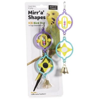 Packaged Product (Left): Ruff 'N' Tumble Mirr 'a' Shapes ICE Bird Toy in original blister pack packaging against a white background. The packaging features a green budgie photo alongside product branding ("I just love to play... Mirr 'a' Shapes ICE Bird Toy", "In Cage Entertainment", and "Go on... ruffle some feathers!"). Unpackaged Toy (Right): A hanging bird toy featuring a silver-colored metal clip at the top, leading to a purple plastic circular frame housing a central yellow oval component with small pastel beads. Suspended below is a teal plastic circular frame containing a yellow star-shaped center piece with a small circular mirror, finished with a silver metal bell hanging at the bottom.