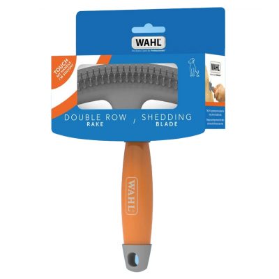 Studio product shot of the WAHL Double Row Rake and Shedding Blade packaged inside its blue and orange cardboard retail sleeve, isolated against a solid white background. The front of the packaging reads "DOUBLE ROW RAKE / SHEDDING BLADE" and features a small orange sticker saying "TOUCH MY HANDLE I'M SQUISHY". The vibrant orange handle with the grey WAHL logo extends downwards from the pack